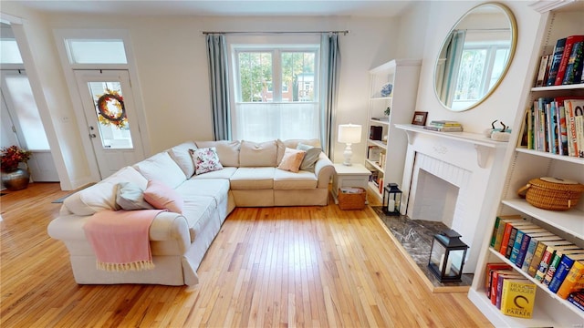 living room featuring a fireplace and light hardwood / wood-style flooring