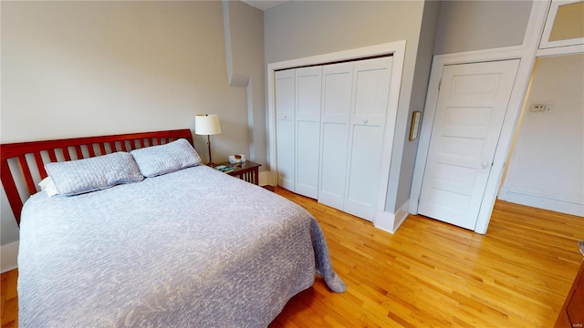 bedroom with hardwood / wood-style floors and a closet