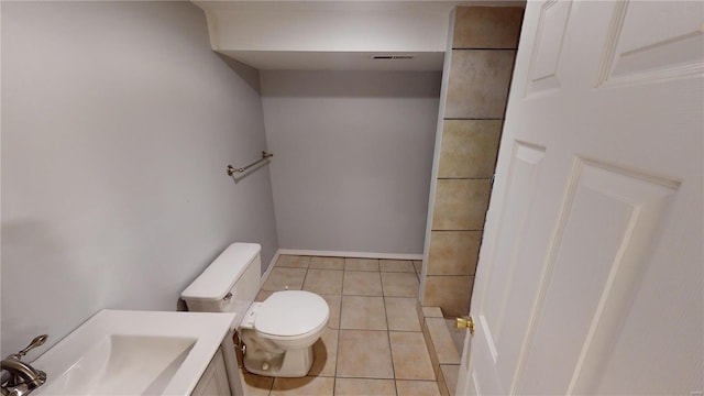 bathroom featuring tile patterned floors, vanity, and toilet