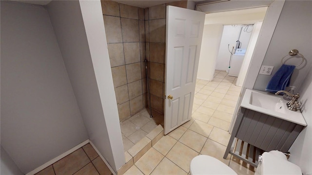 bathroom with tile patterned floors, sink, washer / dryer, and toilet