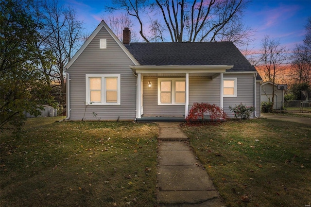 view of front of home with a lawn and covered porch