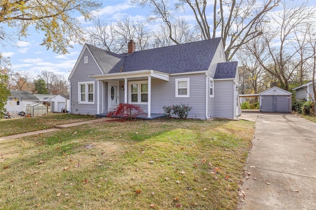 bungalow featuring a front lawn and a storage shed