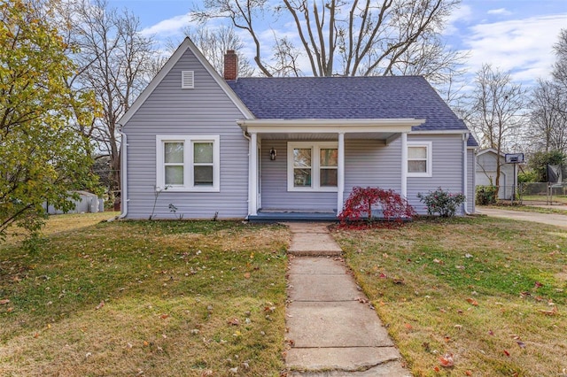 bungalow-style home with a front yard