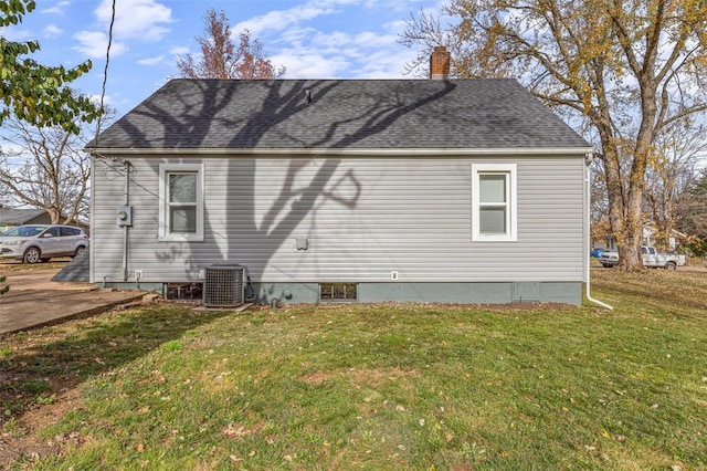 back of house featuring a lawn and central AC