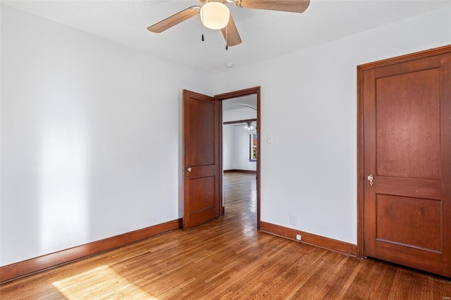 spare room with ceiling fan and light wood-type flooring