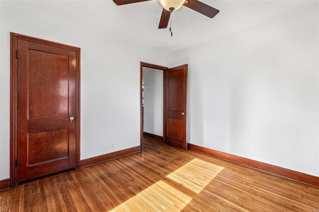 unfurnished bedroom featuring ceiling fan and wood-type flooring