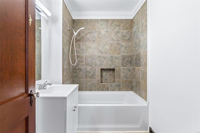 bathroom with tiled shower / bath combo, crown molding, and vanity