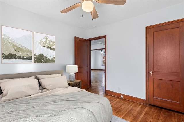 bedroom featuring ceiling fan and dark wood-type flooring