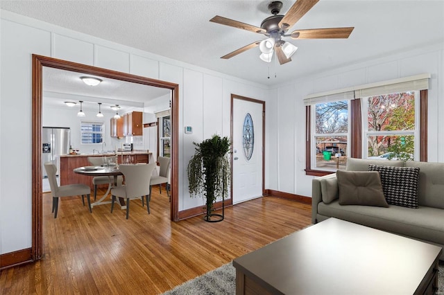 living room featuring hardwood / wood-style floors, a textured ceiling, and a wealth of natural light