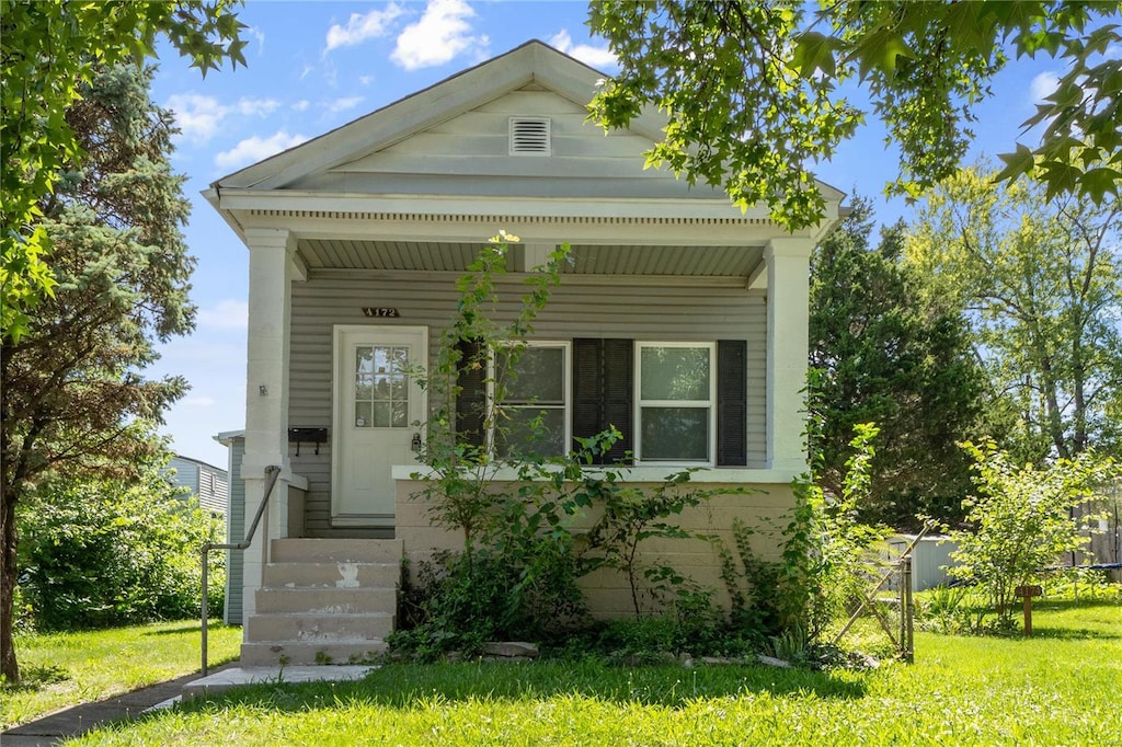 greek revival house with a porch and a front lawn