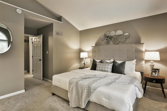 carpeted bedroom featuring lofted ceiling