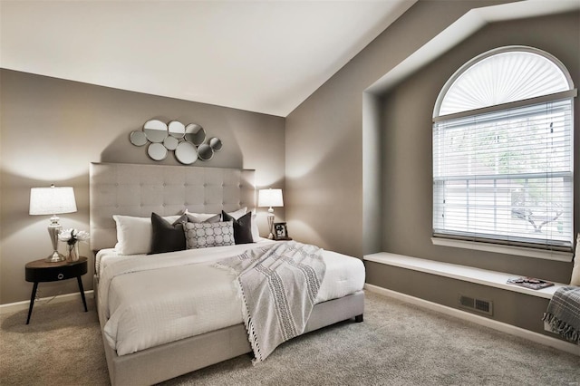 bedroom featuring carpet flooring and vaulted ceiling