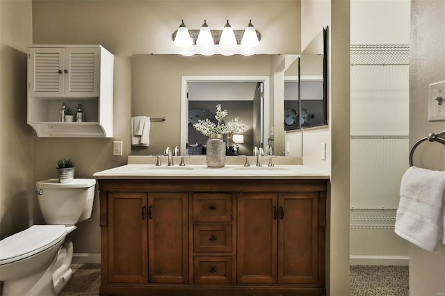 bathroom featuring tile patterned floors, vanity, and toilet