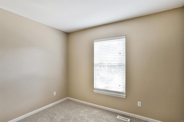 carpeted empty room with plenty of natural light