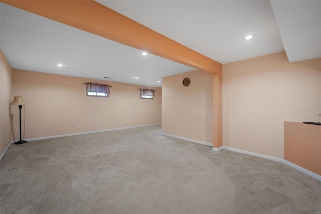 basement featuring light carpet