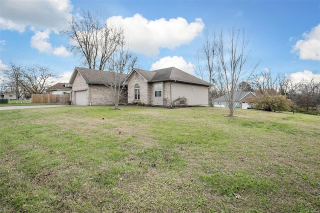 view of home's exterior with a lawn and a garage