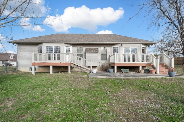 back of property with a yard, a patio, and a deck