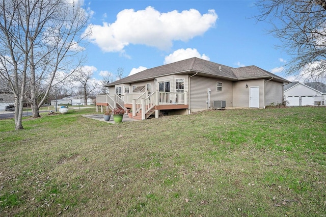 back of property with a lawn, cooling unit, and a wooden deck