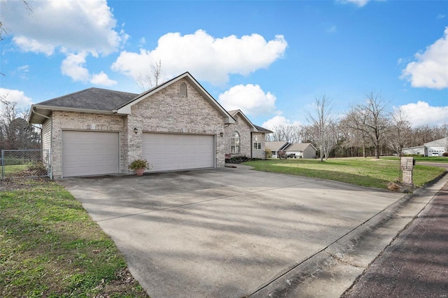 view of side of property with a yard and a garage