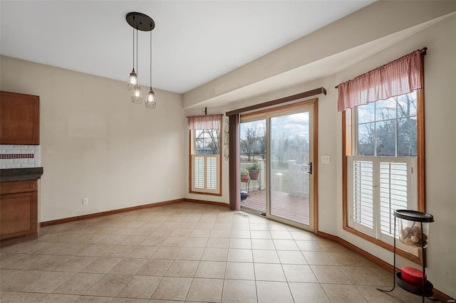 entryway featuring plenty of natural light and light tile patterned flooring