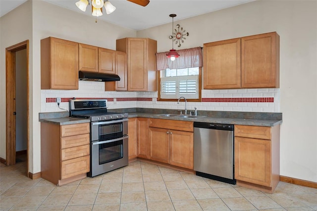 kitchen with sink, hanging light fixtures, backsplash, light tile patterned floors, and appliances with stainless steel finishes