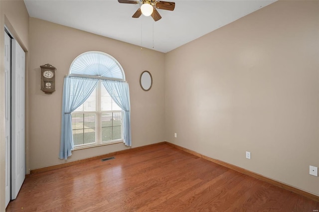 empty room featuring light hardwood / wood-style flooring and ceiling fan