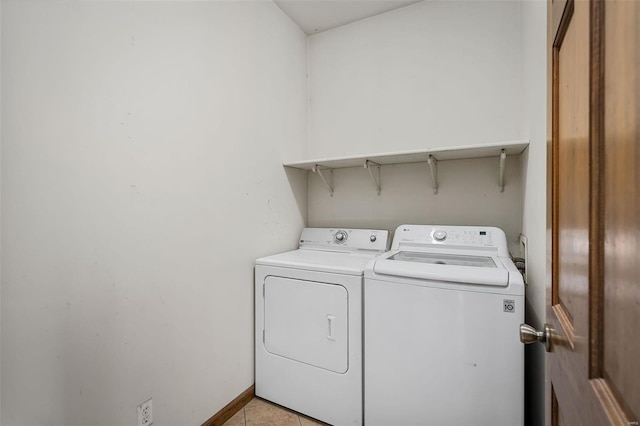 washroom featuring washer and clothes dryer and light tile patterned floors