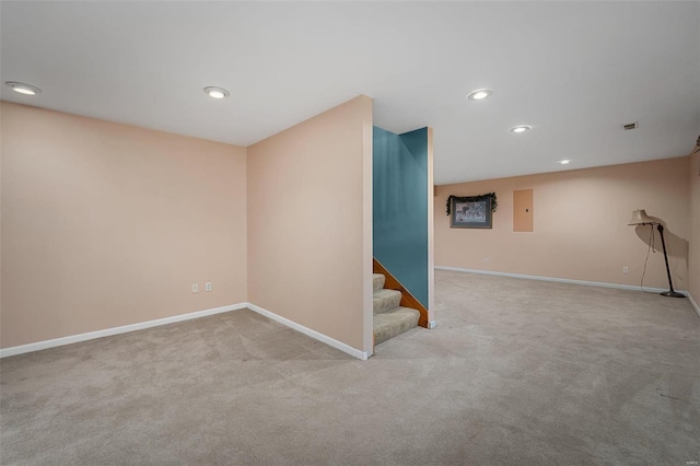 basement featuring electric panel and light carpet