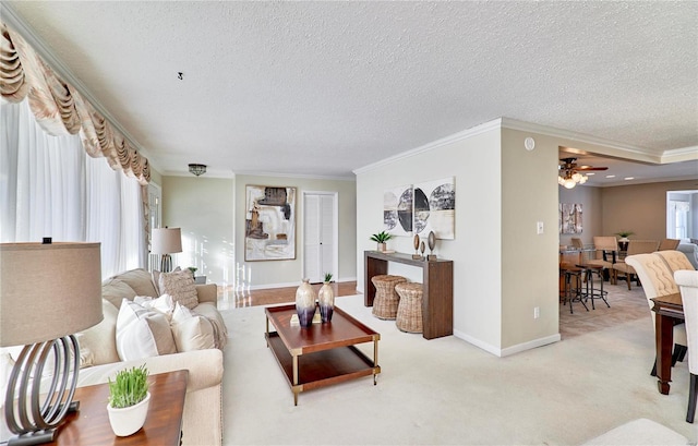 living room featuring light carpet, ornamental molding, and a textured ceiling