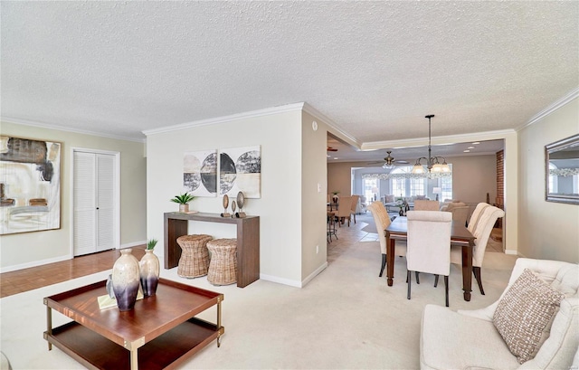 carpeted living room with ceiling fan, a textured ceiling, and ornamental molding