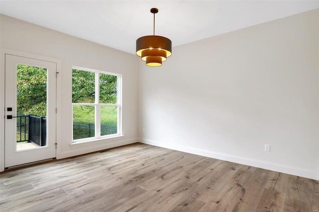 unfurnished dining area with light wood-type flooring