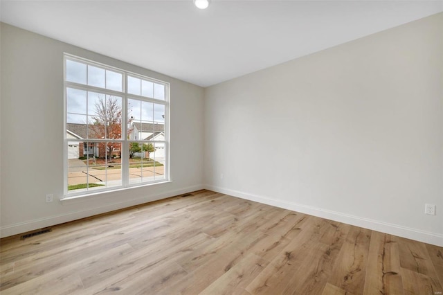 spare room featuring light wood-type flooring