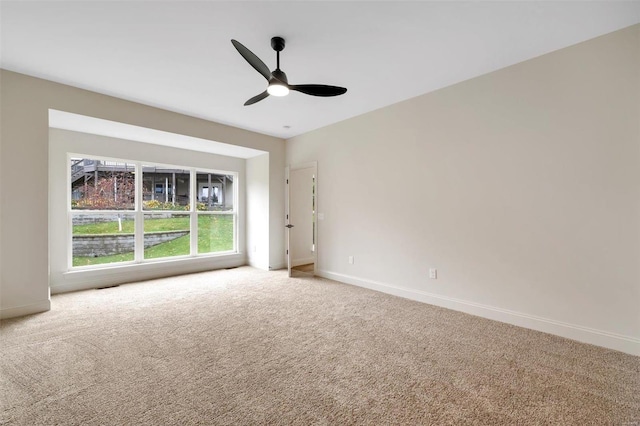 empty room featuring carpet flooring and ceiling fan