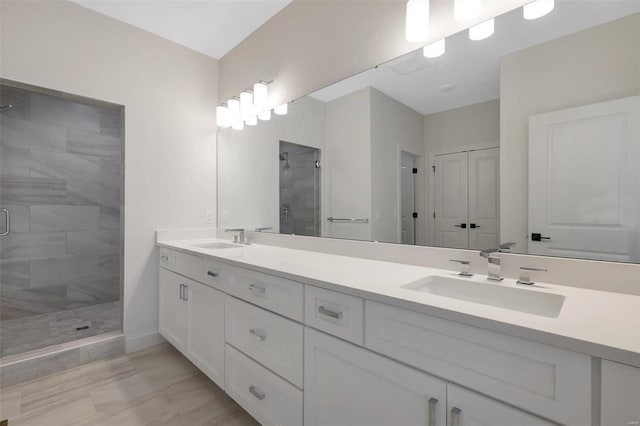 bathroom featuring vanity and an enclosed shower