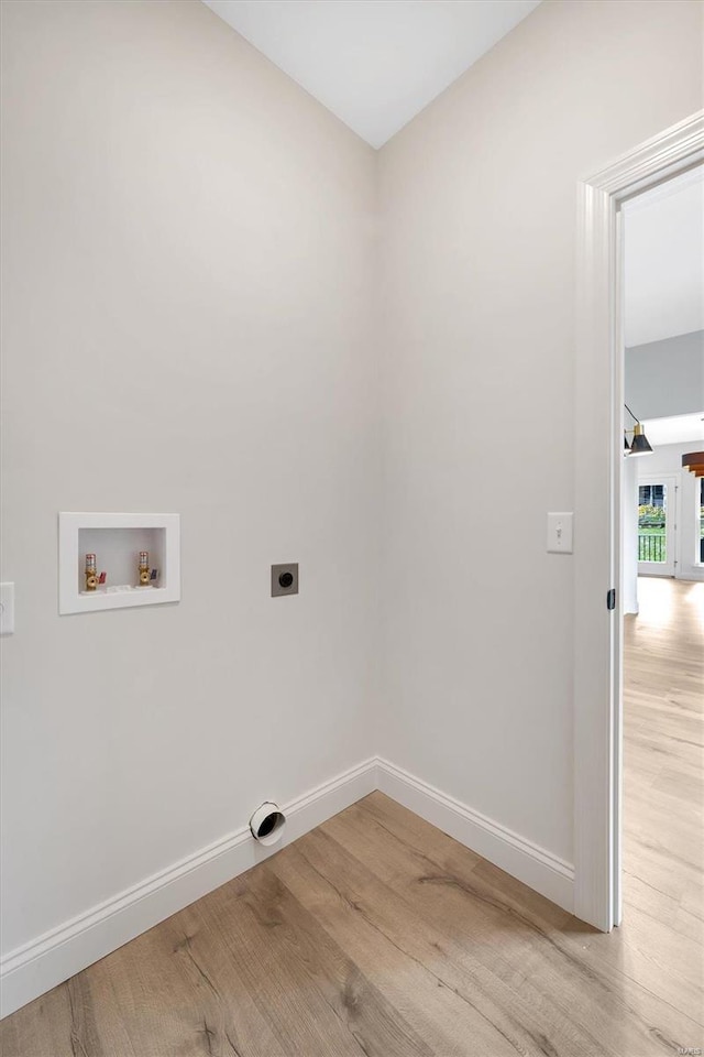 laundry room with hookup for an electric dryer, light hardwood / wood-style floors, and hookup for a washing machine