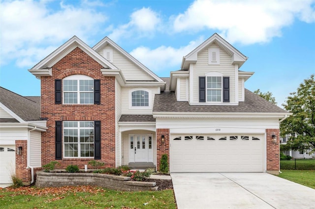 view of property with a garage and a front lawn