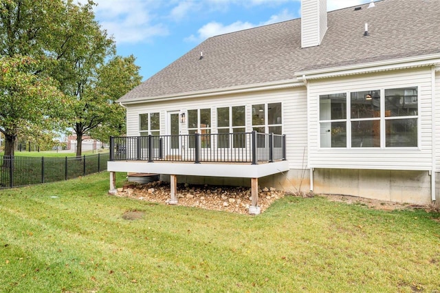 back of house with a yard and a deck