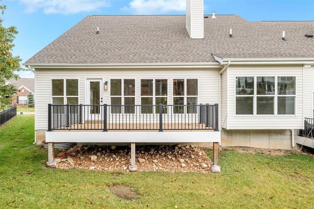 back of house with a wooden deck and a yard