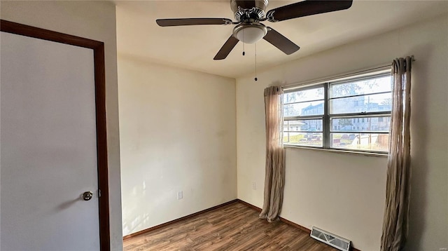 spare room with ceiling fan and wood-type flooring