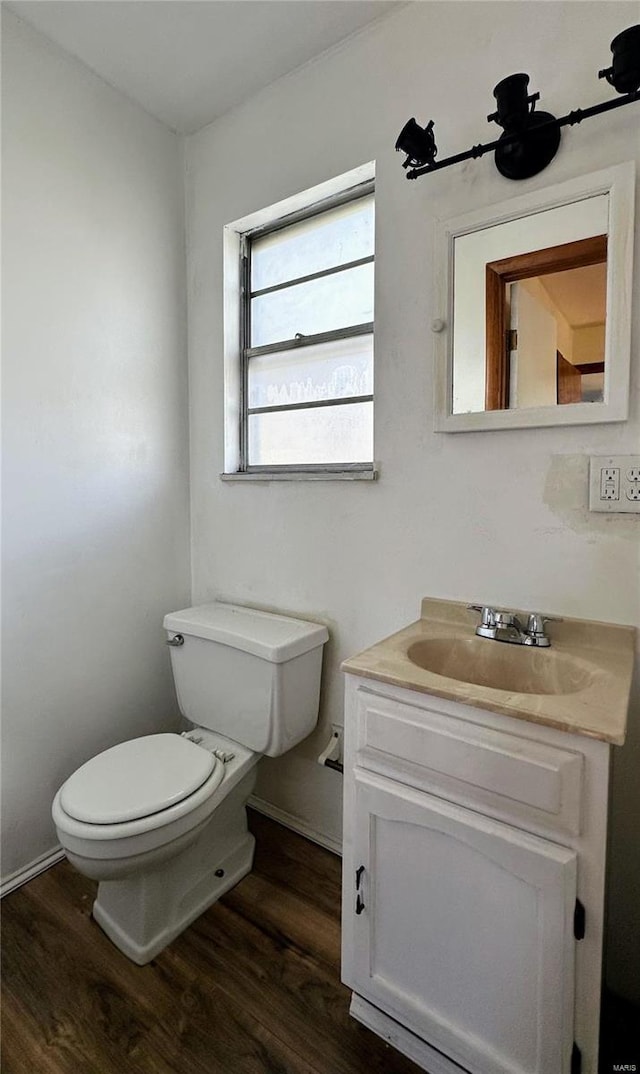 bathroom with vanity, hardwood / wood-style flooring, and toilet