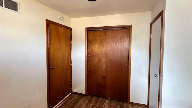 corridor with dark wood-type flooring