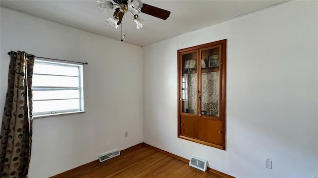 empty room featuring wood-type flooring and ceiling fan