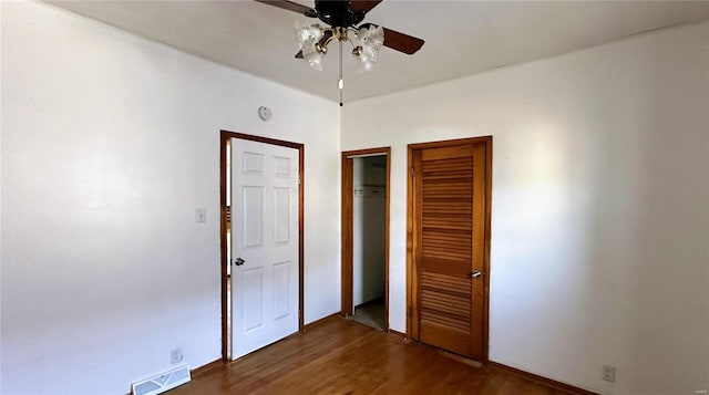 unfurnished bedroom featuring dark hardwood / wood-style floors and ceiling fan