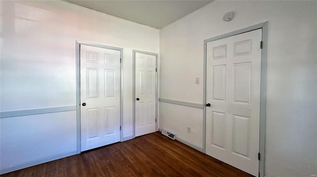 unfurnished bedroom featuring dark wood-type flooring