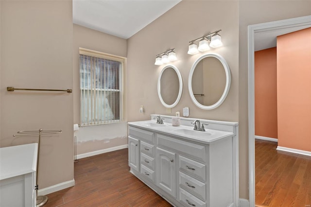 bathroom with hardwood / wood-style floors and vanity