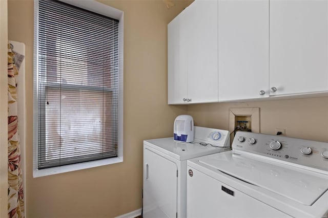 washroom with washing machine and dryer and cabinets