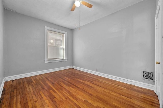 empty room featuring hardwood / wood-style floors, ceiling fan, and a textured ceiling