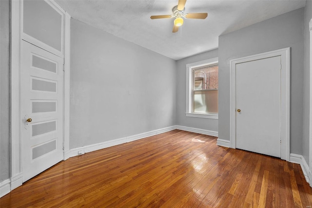 unfurnished bedroom with ceiling fan, a textured ceiling, and hardwood / wood-style flooring