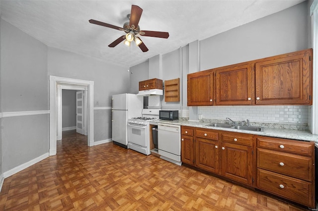 kitchen with white appliances, sink, decorative backsplash, a textured ceiling, and light parquet flooring