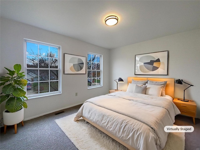 bedroom with carpet flooring and multiple windows